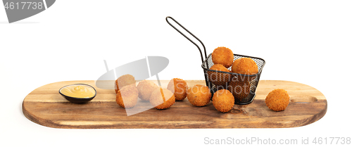 Image of Dutch traditional snack bitterbal on a serving board