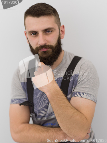 Image of portrait of bearded hipster handyman isolated on white