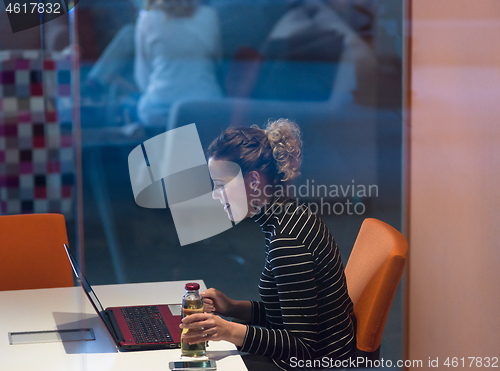 Image of businesswoman using a laptop in startup office