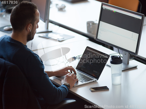 Image of businessman working using a laptop in startup office