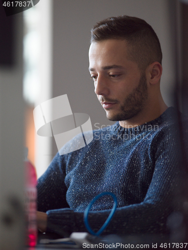 Image of businessman working using a laptop in startup office