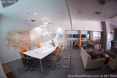 Image of businessman working using a laptop in startup office