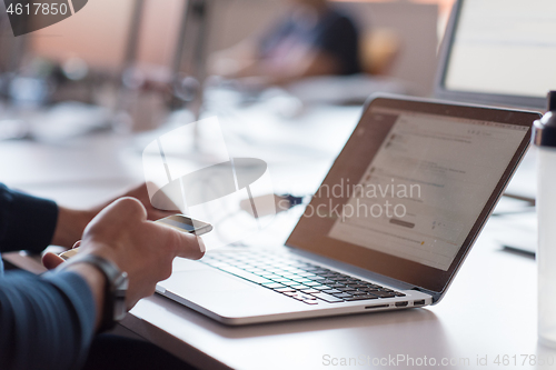 Image of businessman working using a laptop in startup office