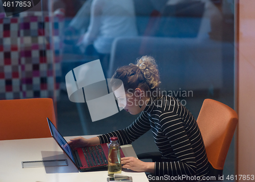 Image of businesswoman using a laptop in startup office