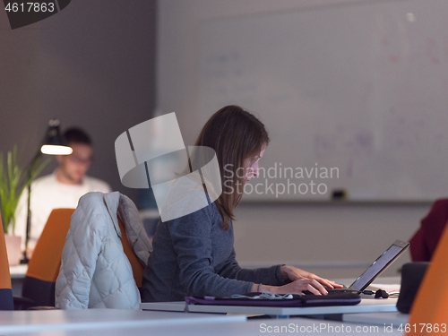 Image of businesswoman using a laptop in startup office