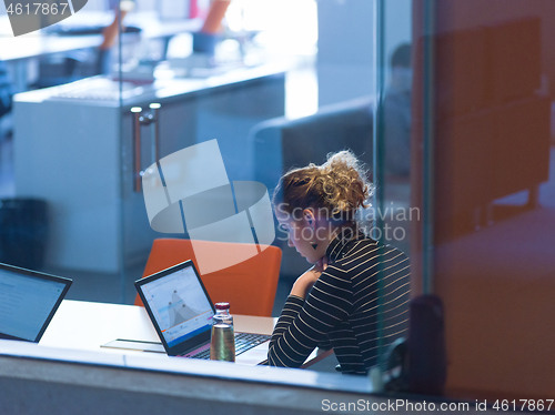 Image of businesswoman using a laptop in startup office