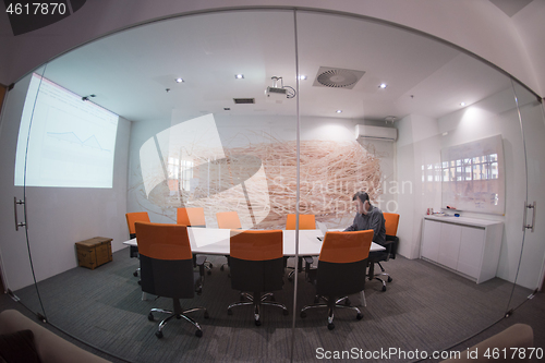 Image of businessman working using a laptop in startup office