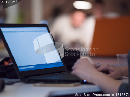 Image of businesswoman using a laptop in startup office