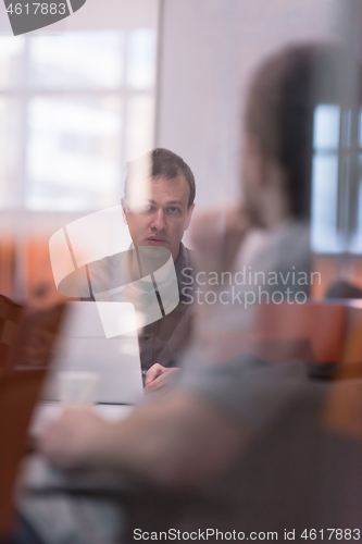 Image of businessman working using a laptop in startup office