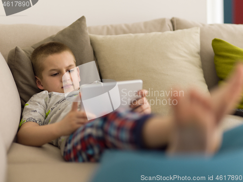 Image of little boy playing games on tablet computers