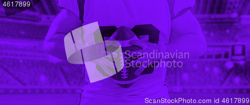 Image of duo toned american football player in  arena at night