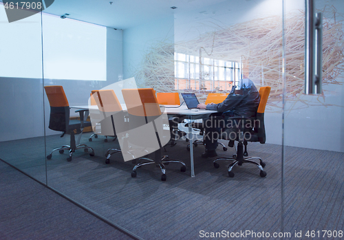 Image of businessman working using a laptop in startup office