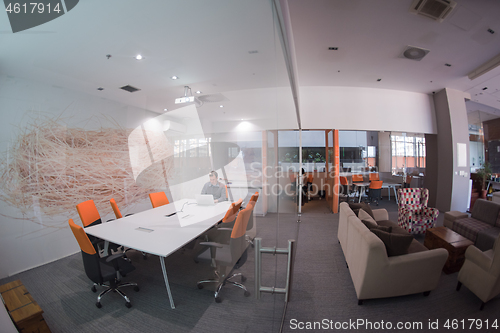 Image of businessman working using a laptop in startup office