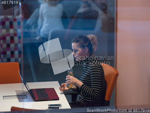 Image of businesswoman using a laptop in startup office