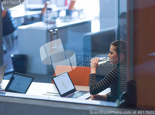 Image of businesswoman using a laptop in startup office