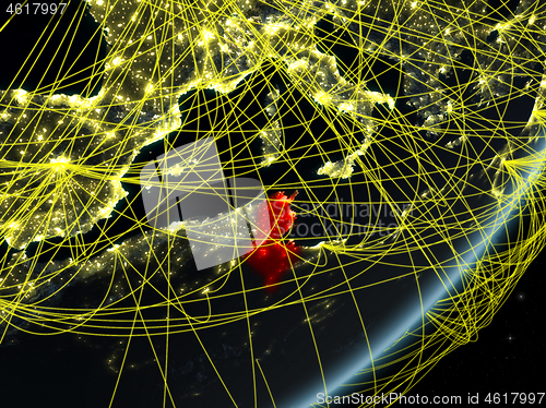 Image of Tunisia on dark Earth with network