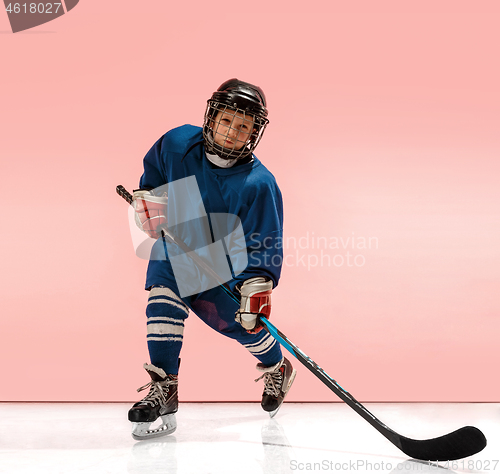 Image of A hockey player with equipment over a pink background