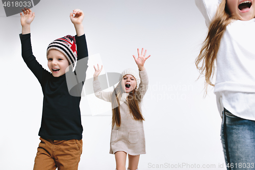 Image of Group of kids in bright winter clothes, isolated on white