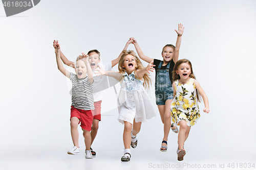 Image of Group fashion cute preschooler kids friends posing together and looking at camera white background