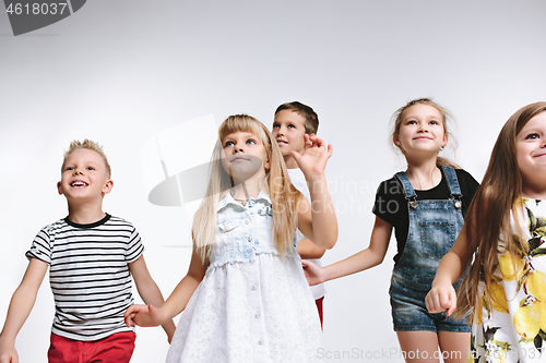 Image of Group fashion cute preschooler kids friends posing together and looking at camera white background