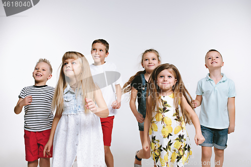 Image of Group fashion cute preschooler kids friends posing together and looking at camera white background