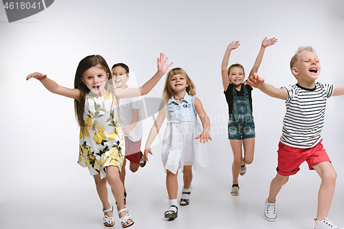 Image of Group fashion cute preschooler kids friends posing together and looking at camera white background