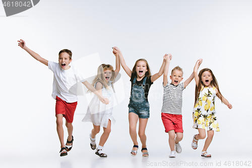 Image of Group fashion cute preschooler kids friends posing together and looking at camera white background