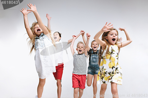 Image of Group fashion cute preschooler kids friends posing together and looking at camera white background