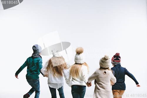 Image of Group of kids in bright winter clothes, isolated on white