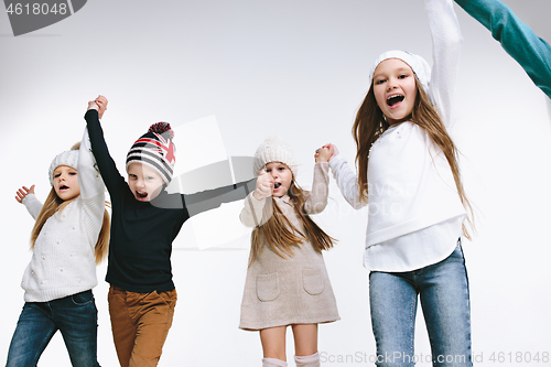 Image of Group of kids in bright winter clothes, isolated on white