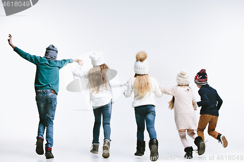 Image of Group of kids in bright winter clothes, isolated on white