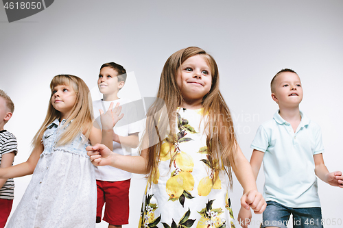 Image of Group fashion cute preschooler kids friends posing together and looking at camera white background