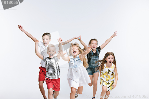Image of Group fashion cute preschooler kids friends posing together and looking at camera white background