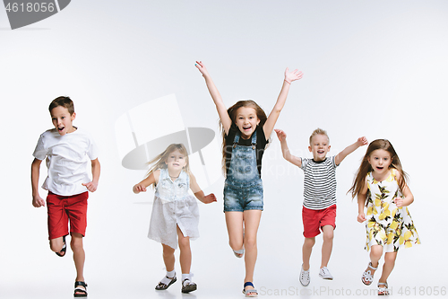 Image of Group fashion cute preschooler kids friends posing together and looking at camera white background
