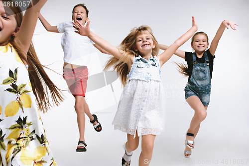 Image of Group fashion cute preschooler kids friends posing together and looking at camera white background