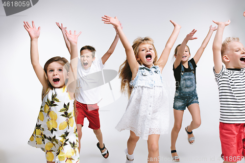 Image of Group fashion cute preschooler kids friends posing together and looking at camera white background