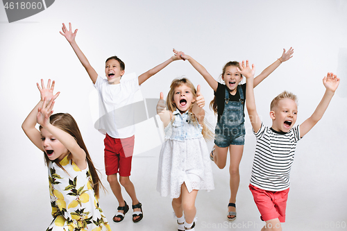 Image of Group fashion cute preschooler kids friends posing together and looking at camera white background