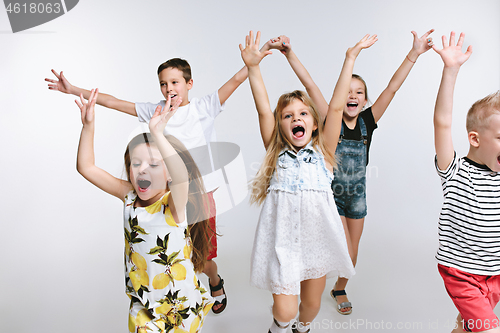 Image of Group fashion cute preschooler kids friends posing together and looking at camera white background