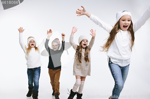 Image of Group of kids in bright winter clothes, isolated on white