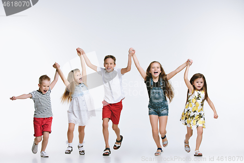 Image of Group fashion cute preschooler kids friends posing together and looking at camera white background