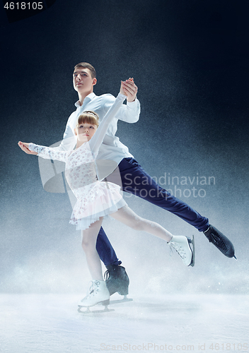 Image of Little girl figure skating at the indoor ice arena.