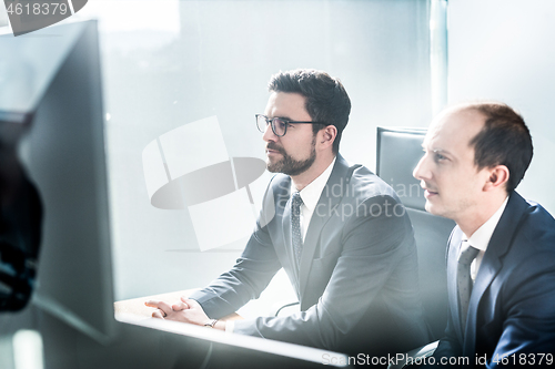 Image of Business team analyzing data at business meeting in modern corporate office.