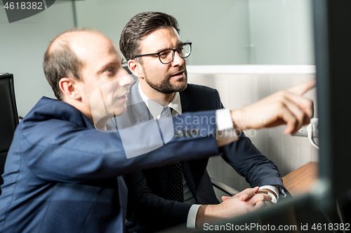 Image of Business team analyzing data at business meeting in modern corporate office.