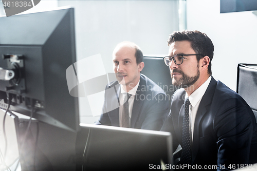 Image of Business team analyzing data at business meeting in modern corporate office.