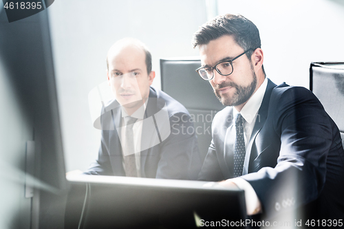 Image of Business team analyzing data at business meeting in modern corporate office.