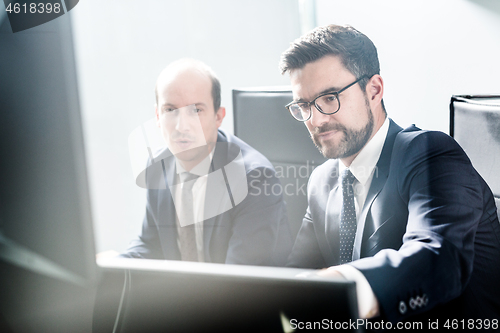 Image of Business team analyzing data at business meeting in modern corporate office.