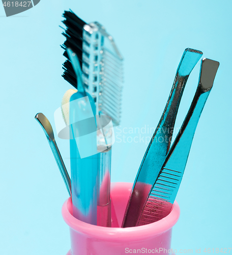 Image of Cosmetic Makeup Tools Represents Eyebrow Tweezers And Brush 