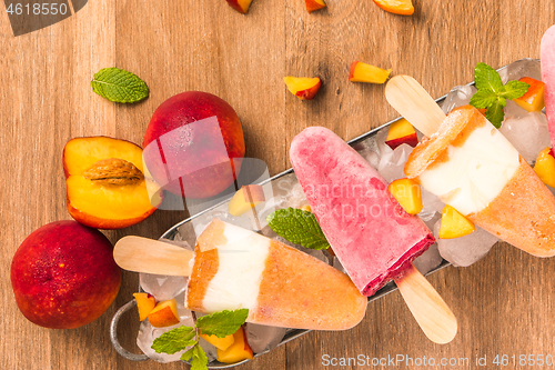 Image of Homemade raspberries and peach popsicles