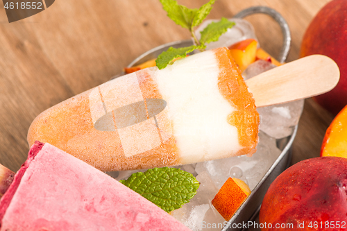 Image of Homemade raspberries and peach popsicles