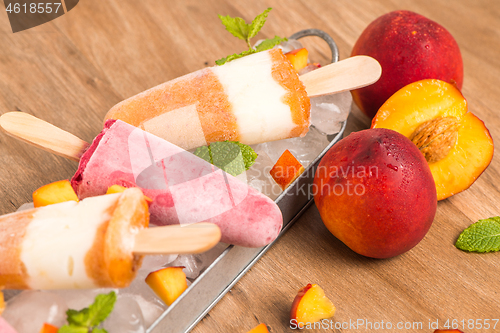 Image of Homemade raspberries and peach popsicles